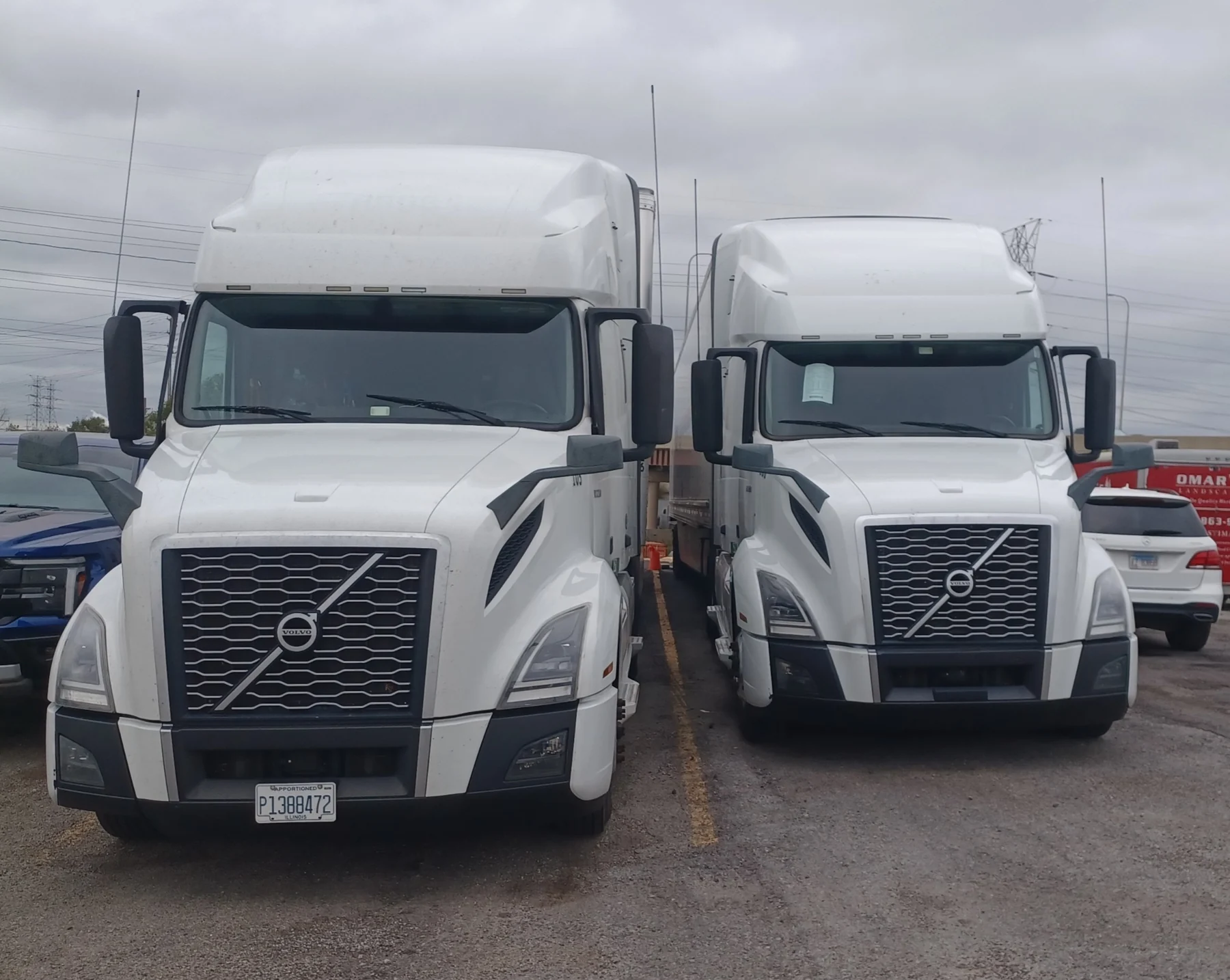 Two white P&G Logistics Volvo tractors